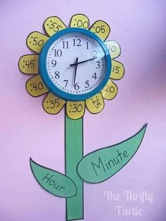 a paper flower clock with the words minute and hour on it