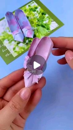 someone is holding an origami butterfly in their hand and it looks like they are making something out of paper