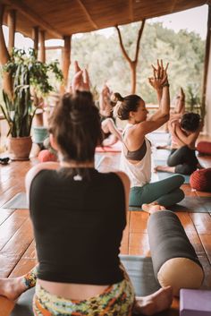 a group of people doing yoga in a room