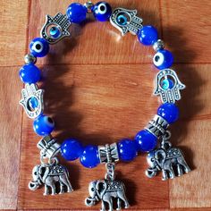 Beaded Blue Bracelet Elephant Evil Eye Hamsa Hand Glass Beads New Without Tags Bohemian Blue Stretch Bracelet With Large Beads, Blue Stretch Bracelet With Colorful Beads For Festival, Festival Stretch Bracelet With Colorful Beads In Blue, Handmade Blue Stretch Bracelet For Festivals, Blue Bohemian Crystal Bracelet With Round Beads, Blue Beaded Bracelets For Festivals With Round Beads, Bohemian Blue Beaded Bracelets With 8mm Beads, Blue Crystal Bracelet With Silver Beads, Blue Beaded Stretch Bracelet For Festival