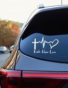 a car with a sticker that says faith hope love and a heart on it