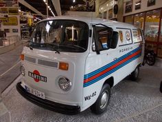 an old white van is parked in a showroom