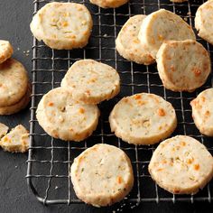 several cookies cooling on a wire rack with orange zest sprinkles next to them