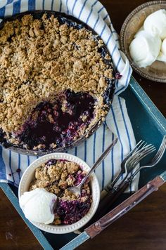 a blueberry crumble pie with ice cream on the side