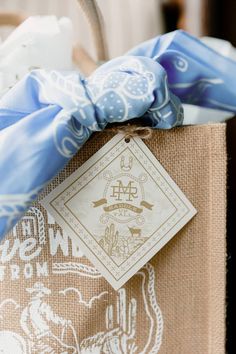 a brown bag with blue and white designs on it's handle is tied to a burlock