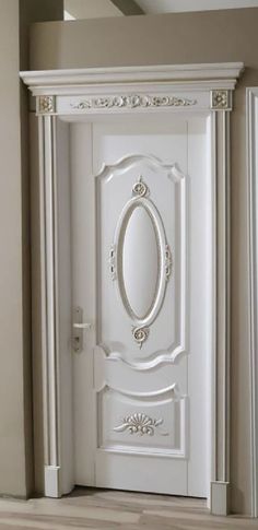 a white door with an oval mirror on the front and side panels, in a room