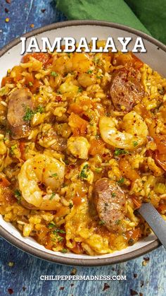 a bowl filled with shrimp, sausage and rice