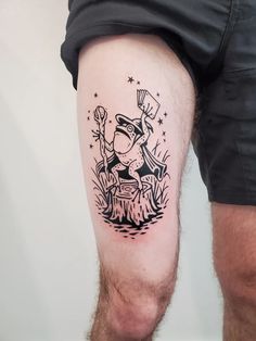 a man's leg with a black and white tattoo of a person on it