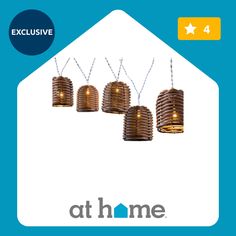 four hanging lights with the words at home above them and an image of a house