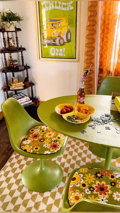 a green table and chairs with plates of food on them