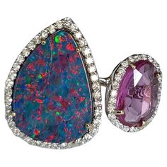 A very gorgeous and beautiful, Doublet Opal & Pink Sapphire Cocktail Ring set in 18K White Gold & Diamonds. The weight of the Doublet Opal is 7.19 carats. The Doublet Opal is of Australian origin. The Opal has a red, green and blue play of colour. The weight of the Pink Sapphire is 2.10 carats. The Pink Sapphire is of Ceylon (Sri Lanka) origin. The Diamonds weight is 0.79 carats. Net 18K Gold weight is 5.48 grams. The Gross weight is 7.50 grams. The dimensions of the ring are 2.30cm x 3.00cm x 2 Sapphire Cocktail Ring, Australian Opal Ring, Diamond Cocktail Rings, 18k Gold Ring, Natural Emerald, Cocktail Ring, Opal Rings, Pink Sapphire, Cocktail Rings