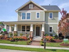 a house with landscaping in front of it and a mailbox on the side walk