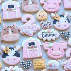 decorated cookies with farm animals, pigs and horses on them for a baby's first birthday