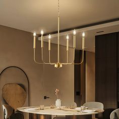 a dining room table with chairs and a chandelier hanging from the ceiling over it