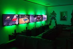 a living room with green lighting and pictures on the wall