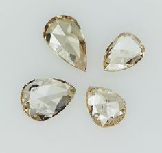 four pieces of diamond on a white surface with one cut in half and the other side missing