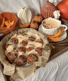 a table topped with lots of different types of desserts and pumpkins on top of it