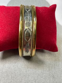 Beautiful sterling, brass and 14 k gold cuff. Created by Alvin Toadacheene. Navajo silver smith. Hall marked with his T with 14k and sterling. Exquisite piece.  This fits a medium to large wrist. My wrist is 6 1/2 inches and it is at least in inch larger. It may be adjusted but I recommend a bracelet mandrel or a Jeweler. In mint condition Vintage Navajo Jewelry Gold, Bohemian Gold Etched Cuff Bracelet, Gold Bohemian Etched Cuff Bracelet, Ceremonial Engraved Brass Cuff Bracelet, Unique Gold Sterling Silver Cuff Bracelet, Unique Gold Engraved Cuff Bracelet, Unique Gold Etched Cuff Bracelet, Unique Engraved Gold Cuff Bracelet, Traditional Gold Stamped Bracelet