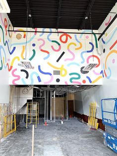 the inside of a building that has been painted with colorful letters and numbers on it