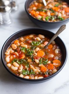 two bowls filled with soup on top of a table