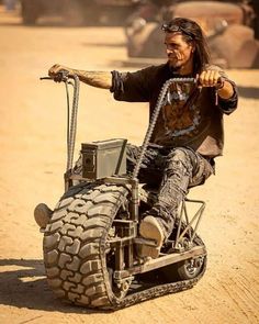 a man riding on the back of an off road vehicle