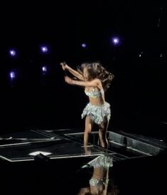 a woman in a belly dance pose on stage