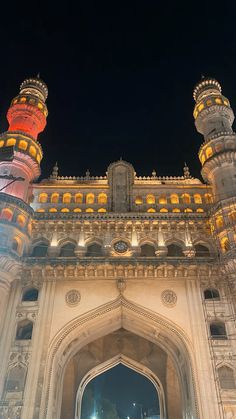 the entrance to an ornate building at night