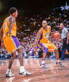 two basketball players are playing on the court in front of an audience at a sporting event