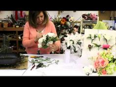 a woman arranging flowers in a flower shop