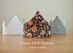 three crowns sitting on top of a wooden table next to each other with the words crown pdf pattern printed on them