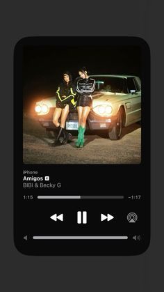 two women sitting on top of a car next to each other