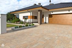 a large house with two garages on each side