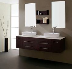 two sinks are shown with mirrors above them in a bathroom area that has dark wood cabinets and white counter tops