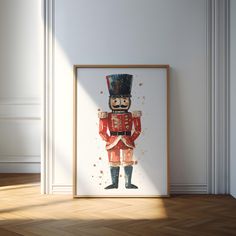 an art print of a nutcracker in red and black, standing against a white wall