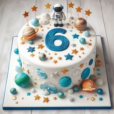 a birthday cake with an outer space theme on the top and number six on the bottom