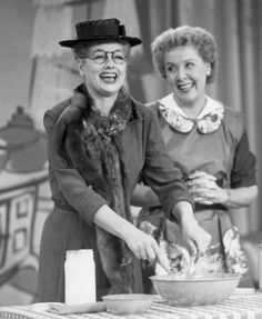 two women in hats are preparing food on the kitchen table with utensils and milk