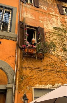 an old building with flowers in the window