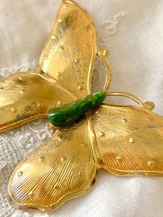 "ALL ITEMS IN SALE SECTION PRICED $15 AND BELOW! This lovely butterfly pin has a natural green stone at its center. The gold tone wings have lifelike designs. Approx. 3\" in width (wingspan) Overall wonderful vintage condition. As shown, the gold tone shows some slight wear on one of the wings. The clasp is in fine working order. Convos invited. FOLLOW ME ON INSTAGRAM @gababoutvintage Is there something in my shop you've fallen in love with but it's a little out of your price range? just convo m Green Butterfly Brooch Jewelry, Butterfly Pin, Fallen In Love, Butterfly Brooch, Price Range, Vintage Brooch, Ruby Ring, Vintage Pins, Green Stone