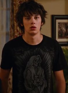 the young man is wearing a t - shirt with a skeleton on it