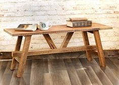 a wooden table with books and a cup on it