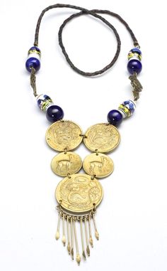 Vintage Peruvian Coin Tribal Beaded Necklace-Statement necklace with 5 jump ring connected Peruvian coins-Hanging from the bottom large coin are brass pins with flattened, pointed ends-Painted scene ceramic beads and dark blue glass beads are connected with 2 brass metal God figural beads-A simple braided leather strand is connected to the beading a coin section-No clasp, simply pull over the head-Length of beaded section approx 9.5"-Drop is about 4.5" including the length of the pins-Total wear Festival Coin Pendant Necklace In Medallion Shape, Handmade Medallion Coin Necklace For Festivals, Antique Coin Pendant Necklace For Festivals, Bohemian Coin Jewelry For Jewelry Making, Handmade Antique Coin Necklace For Festival, Antique Handmade Coin Necklace For Festival, Bohemian Brass Coin Necklace, Traditional Brass Coin Pendant Jewelry, Bohemian Bronze Jewelry With Brass Buttons