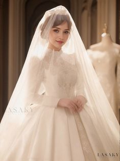 a woman wearing a wedding dress and veil in front of mannequin dummys