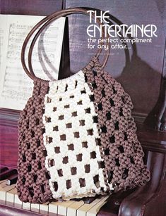 a crocheted purse sitting on top of a piano