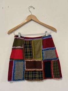 a multicolored patchwork skirt hanging on a hanger