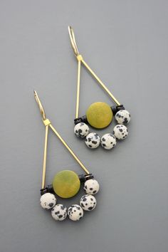 Gold plated brass hooks with black vulcanite, green painted wood, and Dalmatian beads. Each earring weighs .195 oz. and measures 3 inches long. Unique Wooden Bead Dangle Jewelry, Unique Wooden Beads Dangle Jewelry, Adjustable Dangle Jewelry With Wooden Beads, Unique Green Jewelry With Black Beads, Brass Hooks, Jewelry Making Earrings, Brass Hook, Making Earrings, Multi Strand Necklace