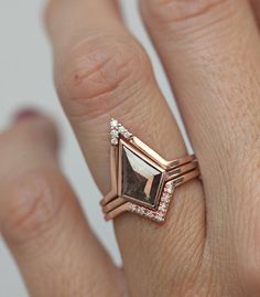 a close up of a person's hand with a diamond ring on their finger