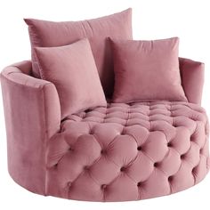 a pink couch with two pillows on it and one pillow in the shape of a circle