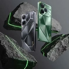 two cameras are shown next to some rocks and green lights on the back of them