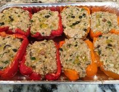 several stuffed peppers in a pan on a counter