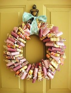 a wreath on the front door with bows and ribbons hanging from it's side